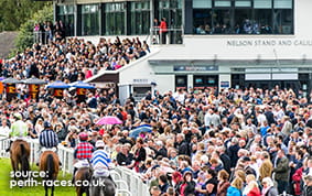 The Grandstand at Perth Racecourse with huge adulating crowds looking at the jockeys