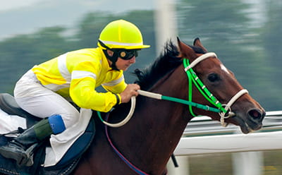 A modern jockey riding at Sandown Park Racecourse