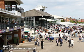 The Grandstand at Stratford on Avon Racecourse with many spectators