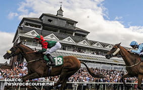 The Grandstand at Thirsk Racecourse with horses racing in the foreground