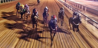 Horses racing on a dirt track