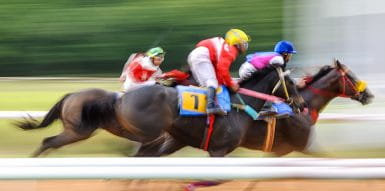 Jockey and horse racing on a track